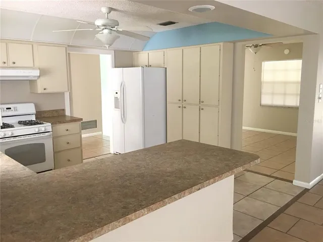 a kitchen with stainless steel appliances a refrigerator and a stove top oven