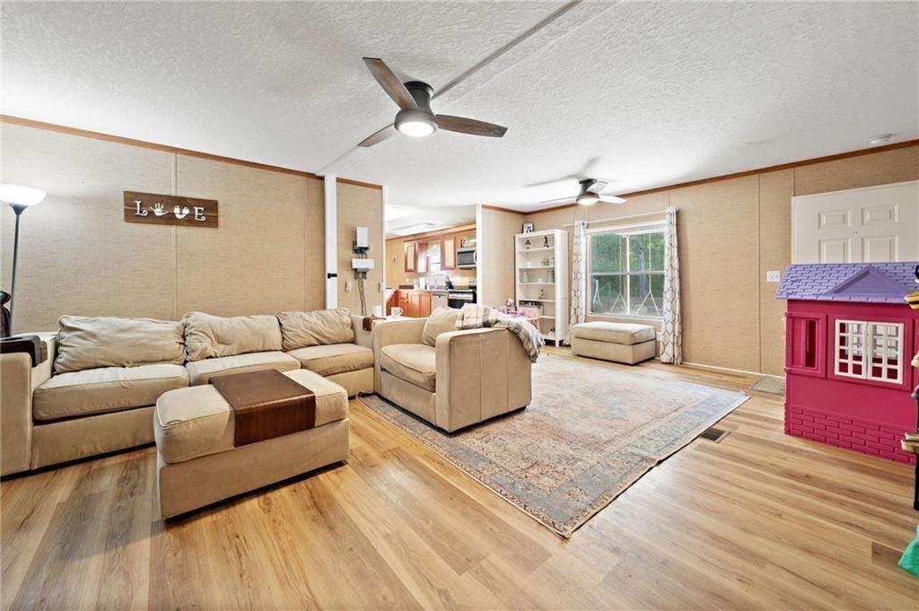 1575 Davis Road West Fairmount, GA 30139 - Photo 11 of 49 a living room with furniture and a large window