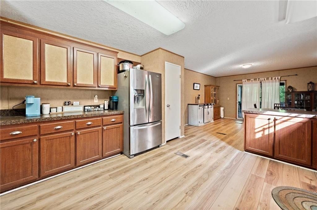 1575 Davis Road West Fairmount, GA 30139 - Photo 14 of 49 a kitchen with stainless steel appliances granite countertop a refrigerator a sink dishwasher a stove and white countertops with wooden floor