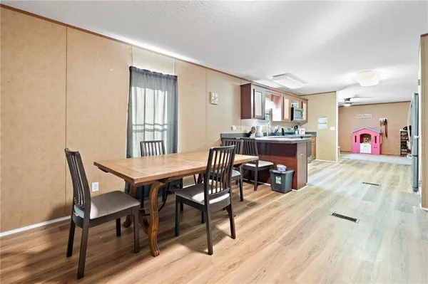 a view of a dining room with furniture window and wooden floor