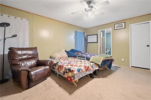 a bedroom with a bed couch and window