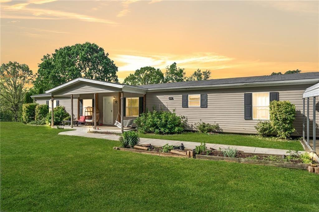 1575 Davis Road West Fairmount, GA 30139 - Photo 2 of 49 a front view of a house with a garden