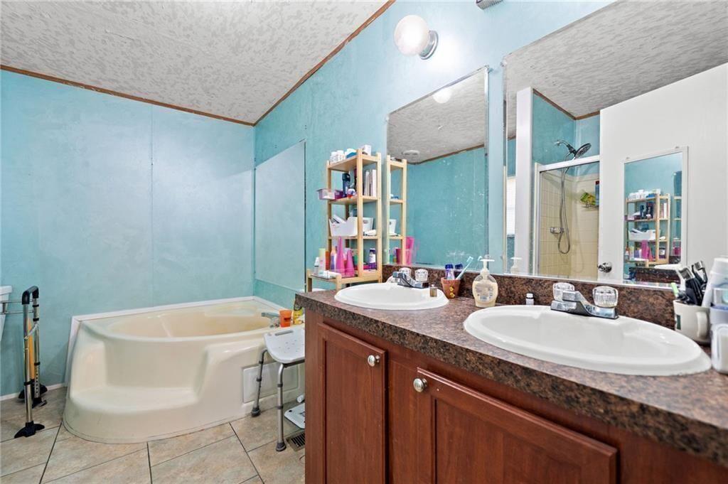 1575 Davis Road West Fairmount, GA 30139 - Photo 21 of 49 a bathroom with a granite countertop sink and a mirror