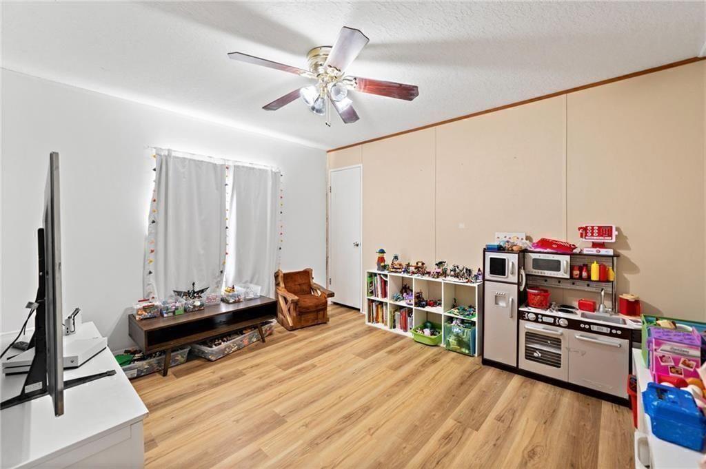 1575 Davis Road West Fairmount, GA 30139 - Photo 23 of 49 a bedroom with furniture and a wooden floor