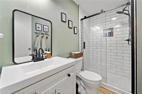 a bathroom with a sink toilet and shower
