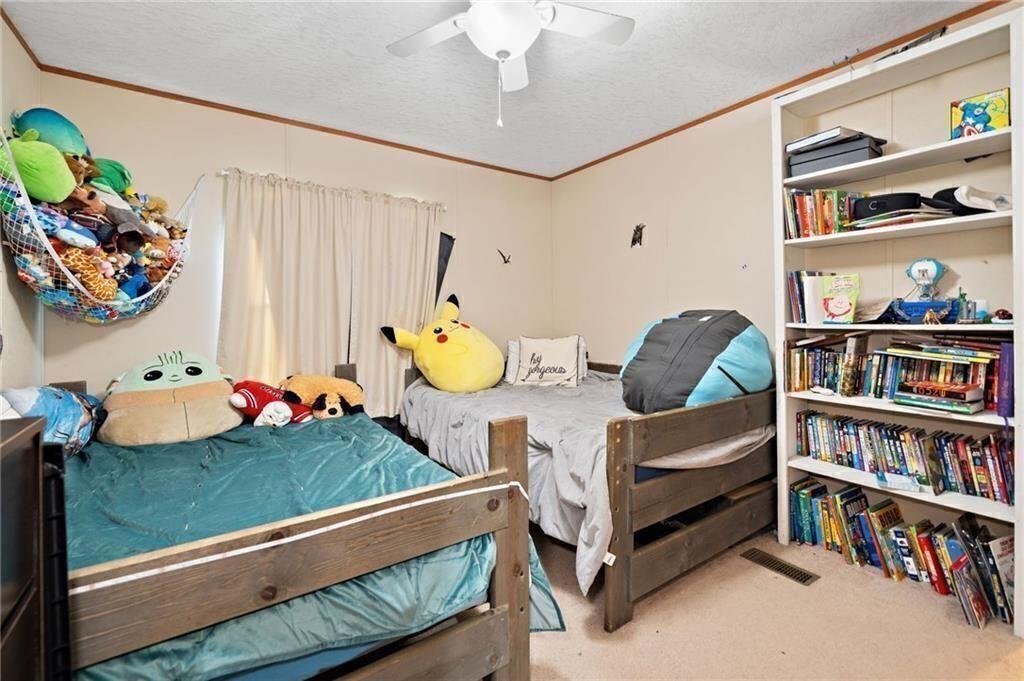 1575 Davis Road West Fairmount, GA 30139 - Photo 25 of 49 a living room with furniture and a book shelf