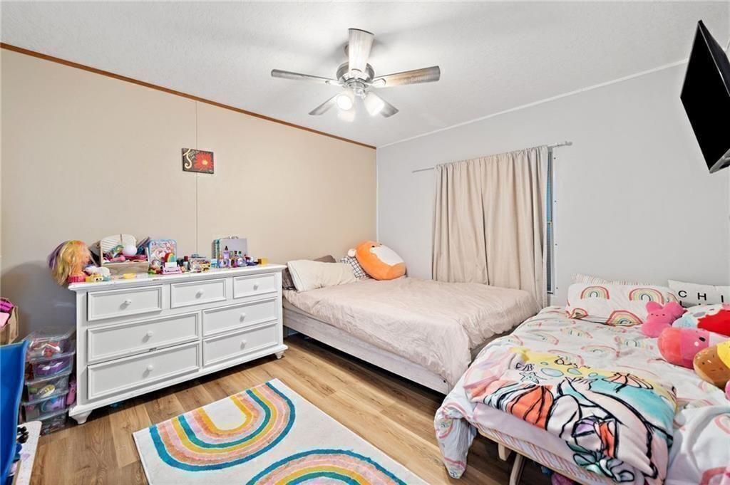 1575 Davis Road West Fairmount, GA 30139 - Photo 26 of 49 a bedroom with a bed and a chandelier