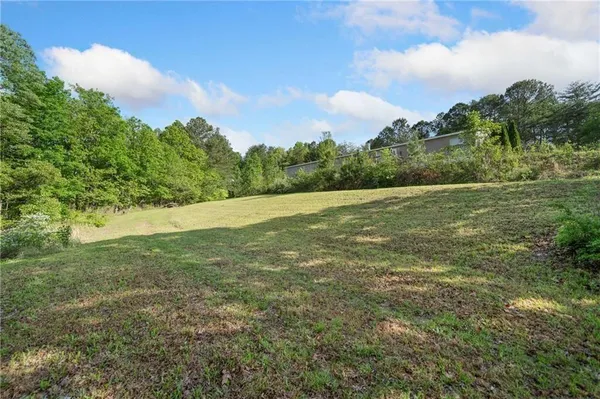 a view of a field with an trees in the background