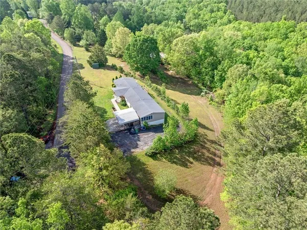 an aerial view of a house with a yard