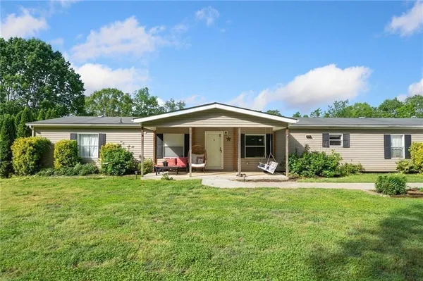 a front view of a house with a yard and porch