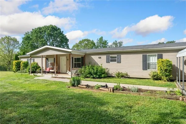 a front view of house with a garden and porch
