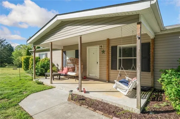 a view of a house with backyard and porch