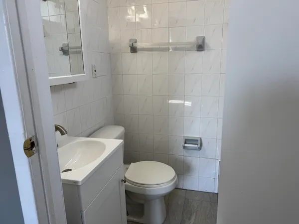 a white toilet sitting next to a white sink
