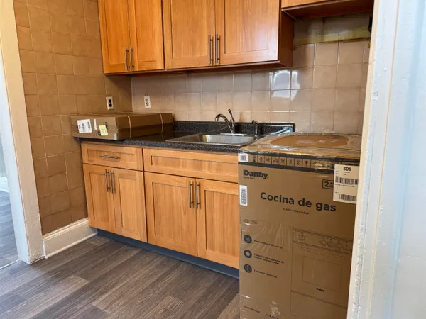 a kitchen with granite countertop cabinets and a stove top oven