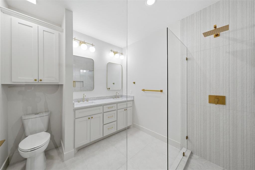 2104 Old McGarrah Road McKinney, TX 75072 - Photo 9 of 35 Dual vanity with white cabinetry and gold-tone hardware