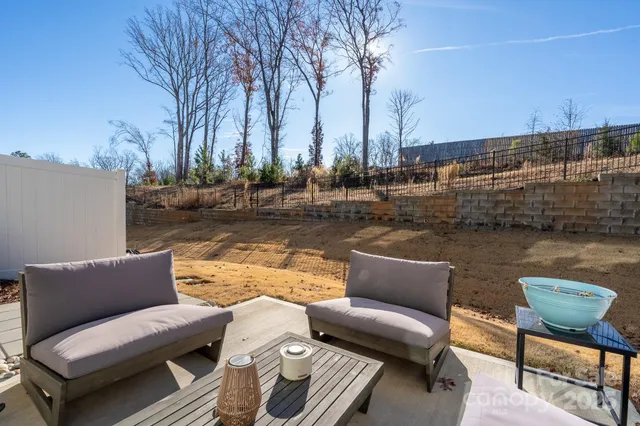 a view of a lake with couches and chairs