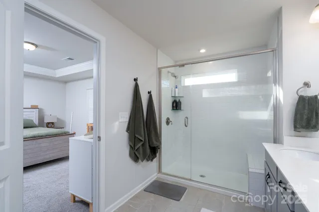 a en suite bathroom with a double vanity sink and a mirror