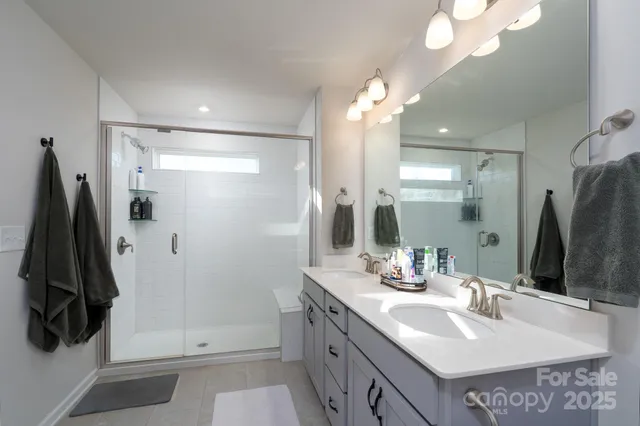 a bathroom with a sink tub and a mirror