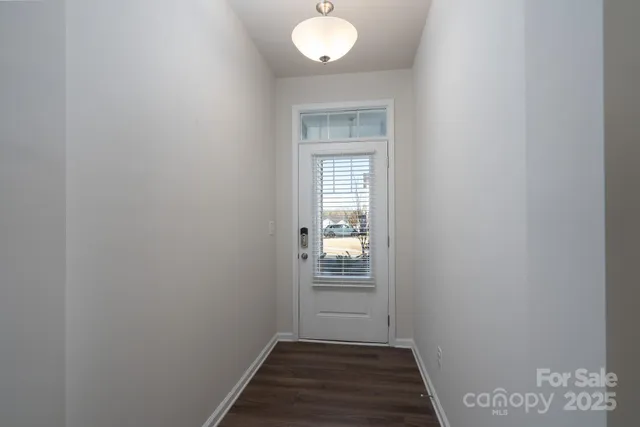 a view of a room with wooden floor and cabinet