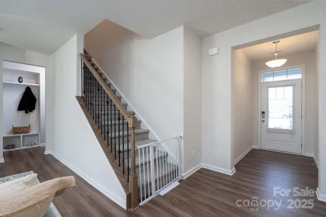 a view of a hallway with wooden floor and entryway