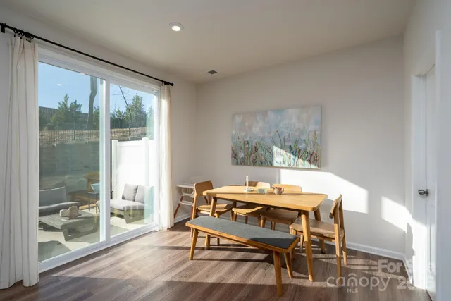 a dining room with furniture and wooden floor