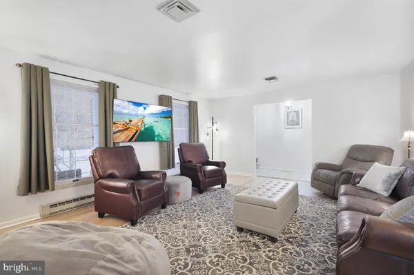 a kitchen with stainless steel appliances a stove a sink a microwave a refrigerator and cabinets