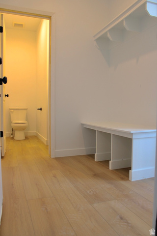 2613 Scarlet Road, Unit 258 Eagle Mountain, UT 84005 - Photo 12 of 32 Light wood-finish flooring extending from the hallway into a powder room