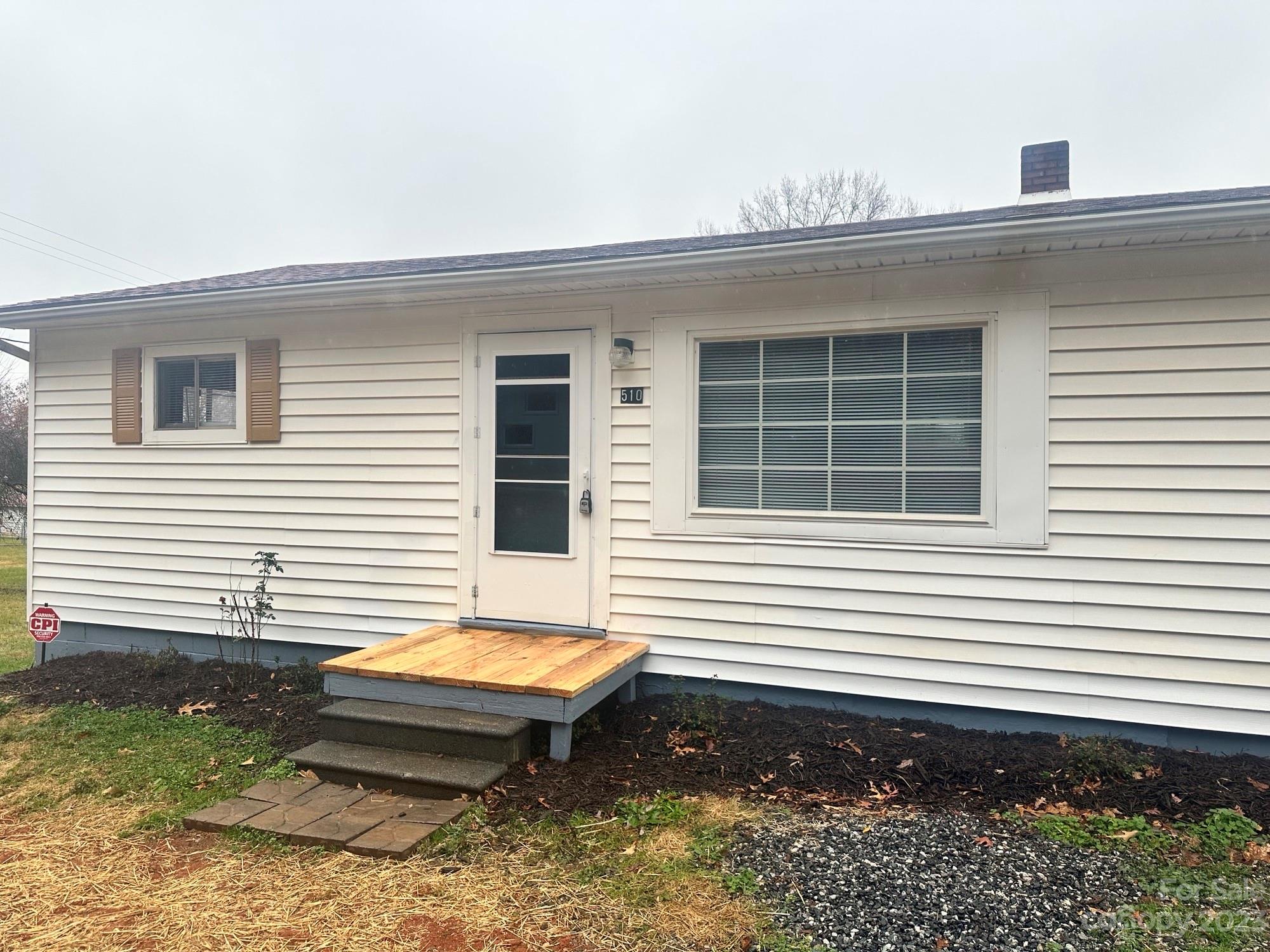 510 Tabor Road Olin, NC 28660 - Photo 3 of 16 a view of a small house with a backyard and sitting area