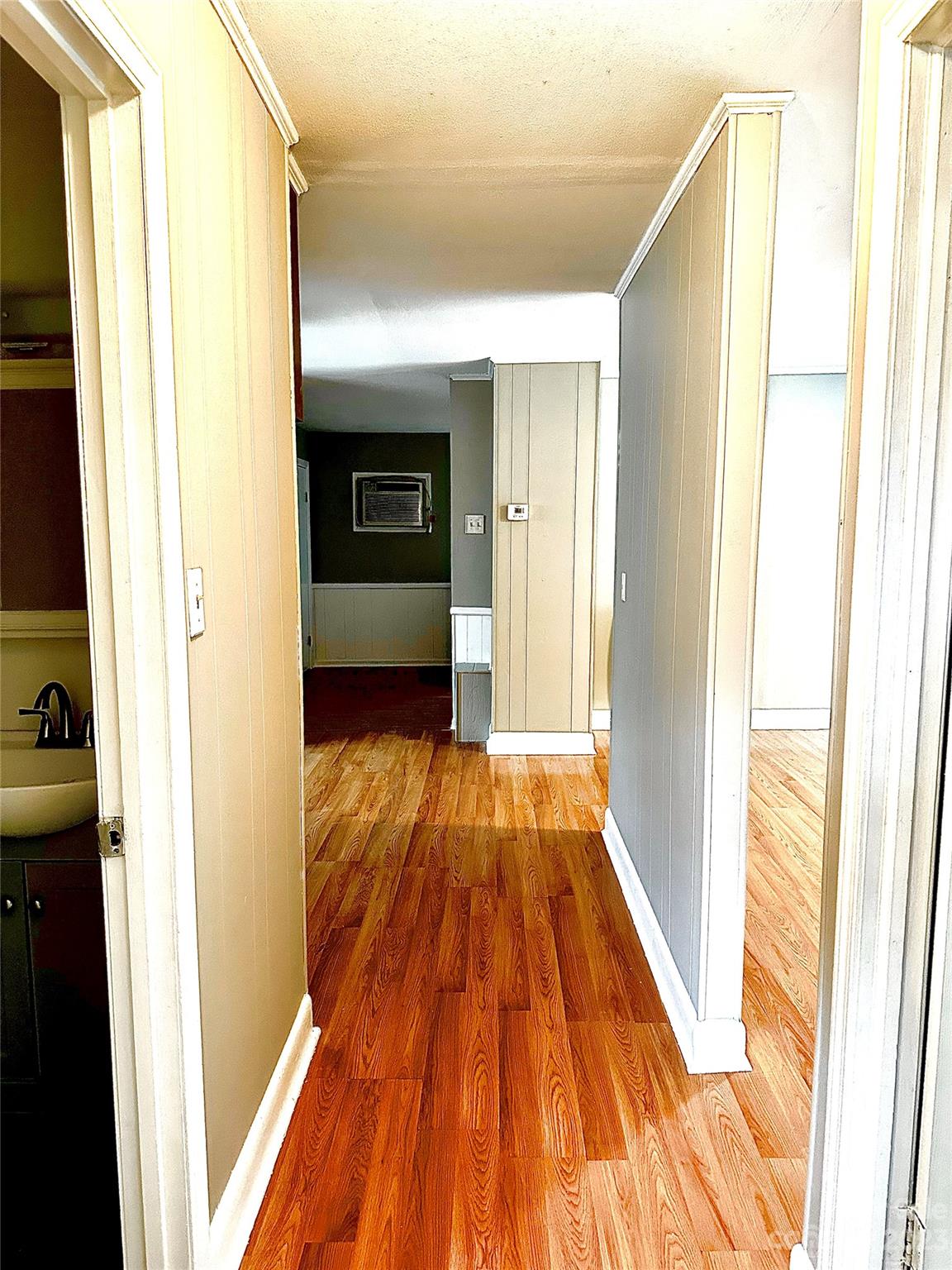 510 Tabor Road Olin, NC 28660 - Photo 8 of 16 a view of a hallway with wooden floor and staircase