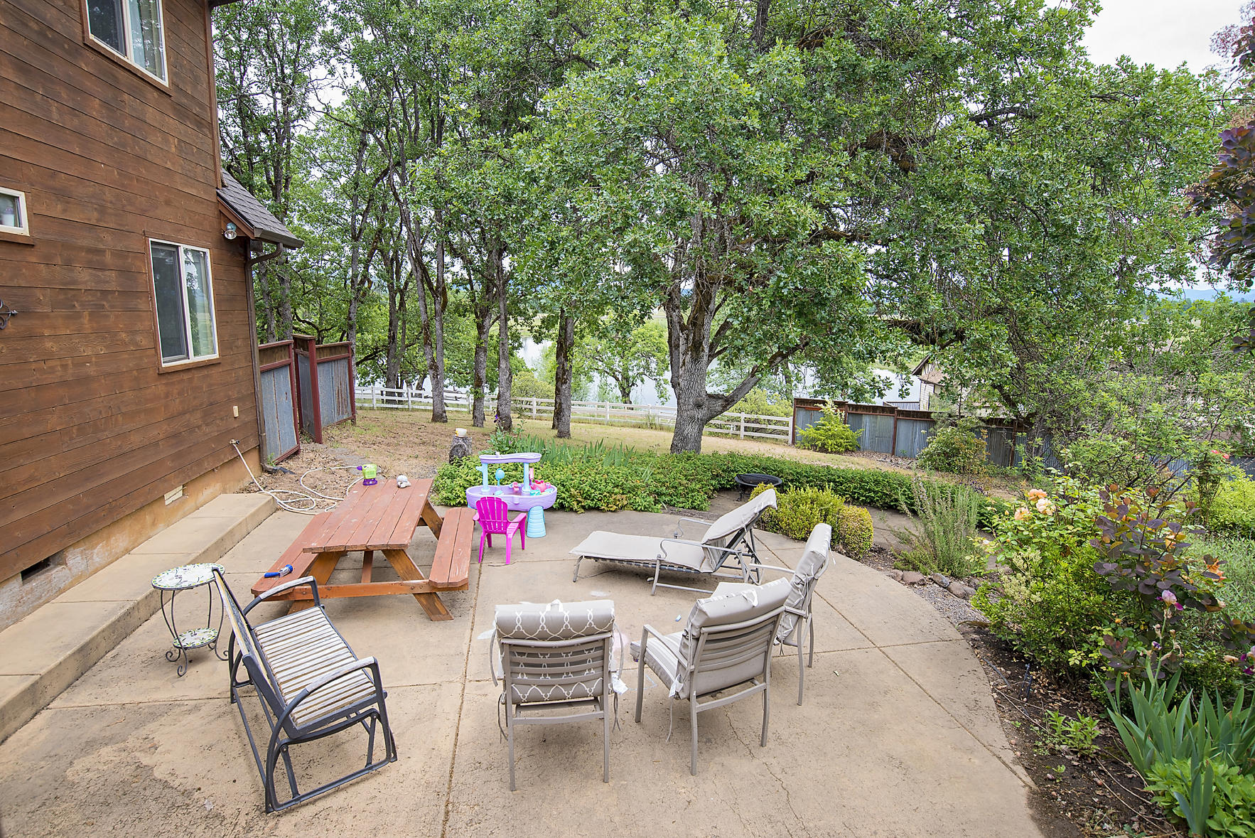 11754 Dixie Road White City, OR 97503 - Photo 38 of 38 a view of a patio with table and chairs and potted plants