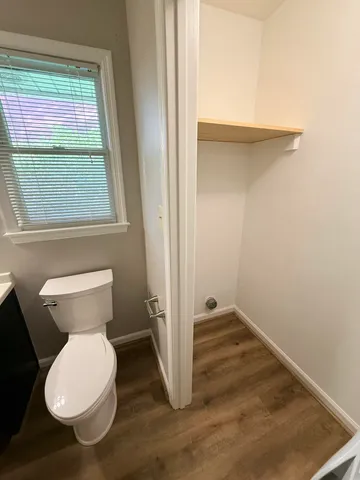 a bathroom with a toilet a sink and a mirror