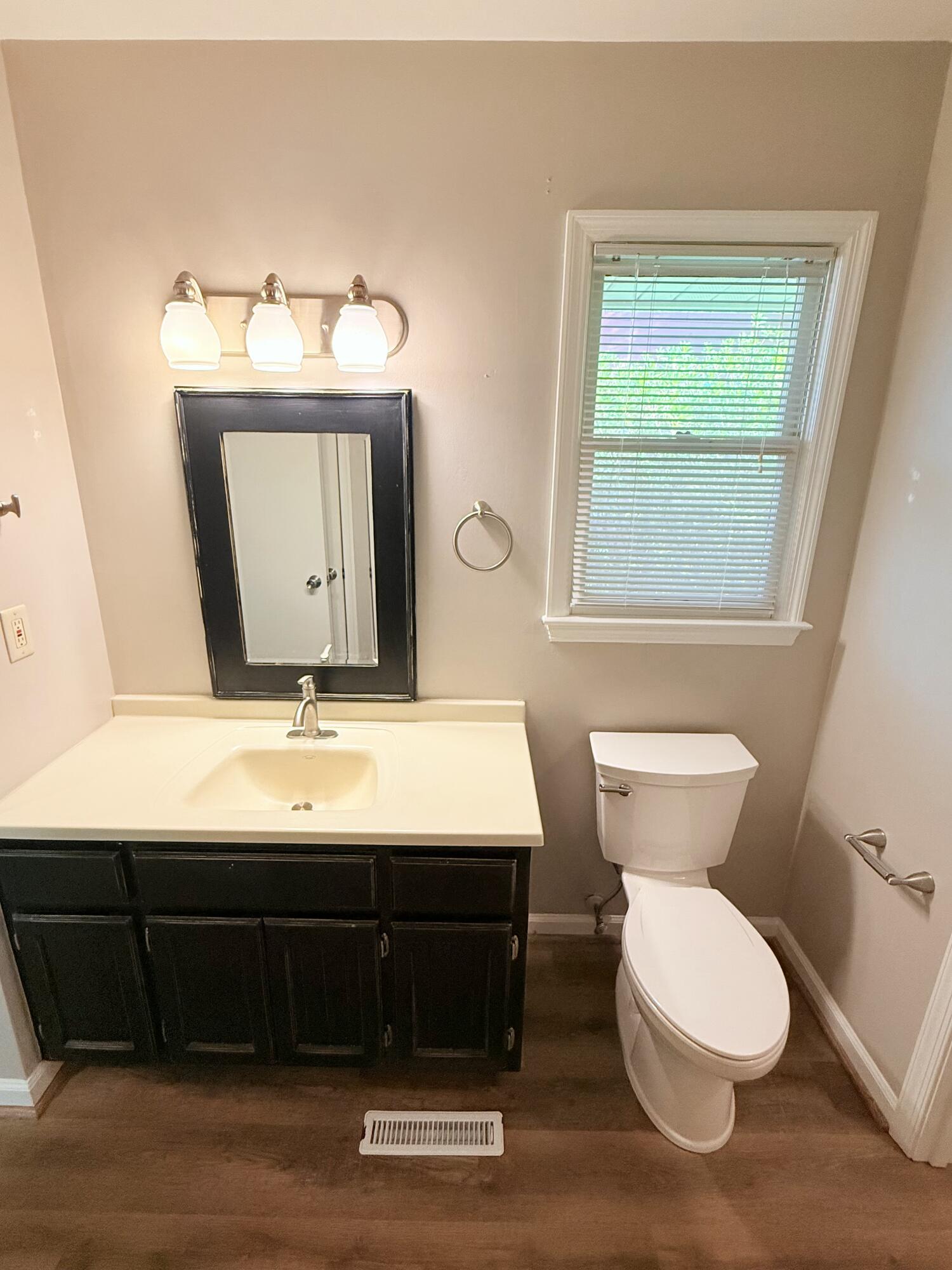 2317 Broadway Avenue Southwest, Unit E Roanoke, VA 24014 - Photo 14 of 20 a bathroom with a toilet a sink and a mirror