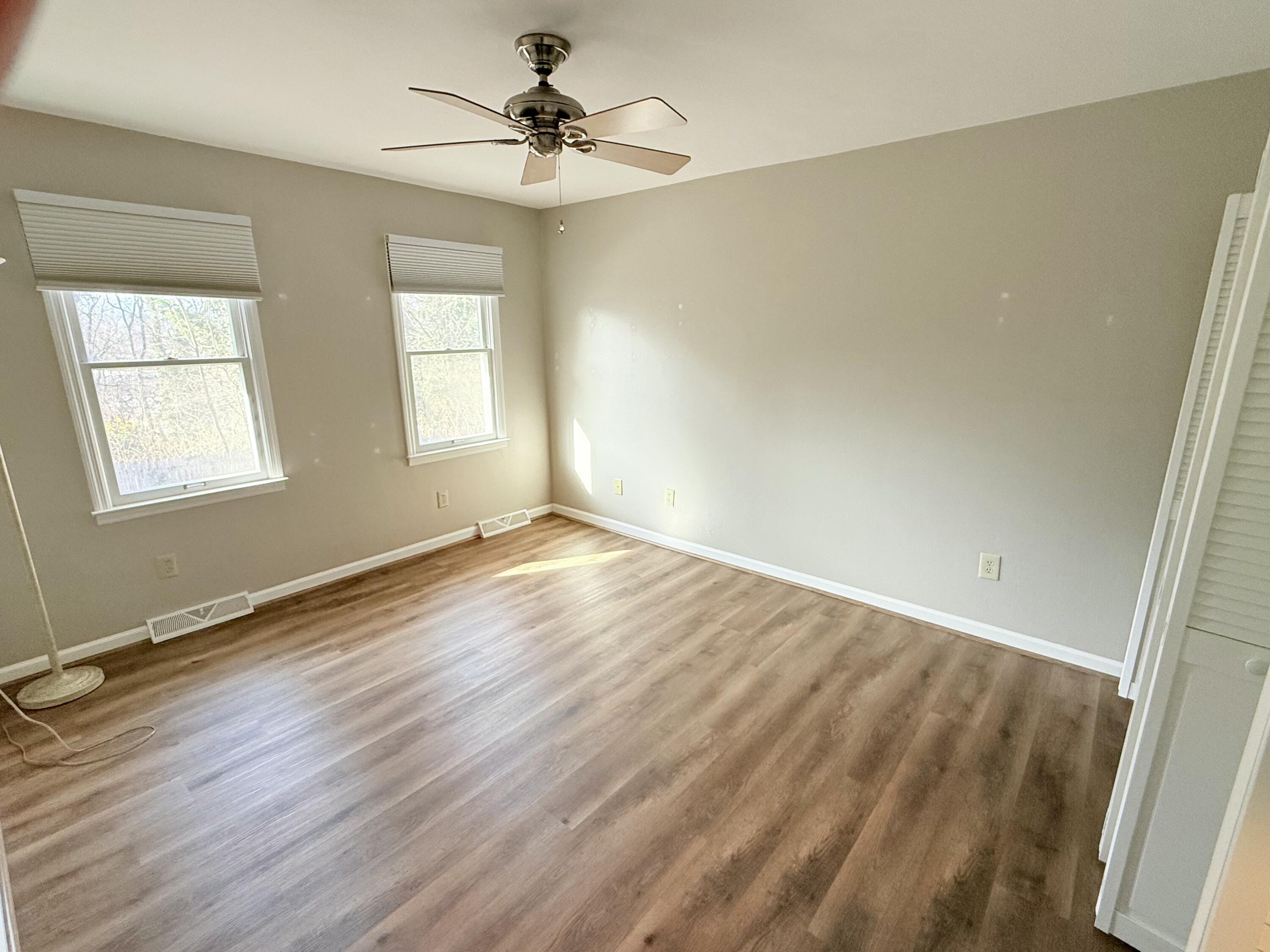 2317 Broadway Avenue Southwest, Unit E Roanoke, VA 24014 - Photo 15 of 20 wooden floor in an empty room with a window