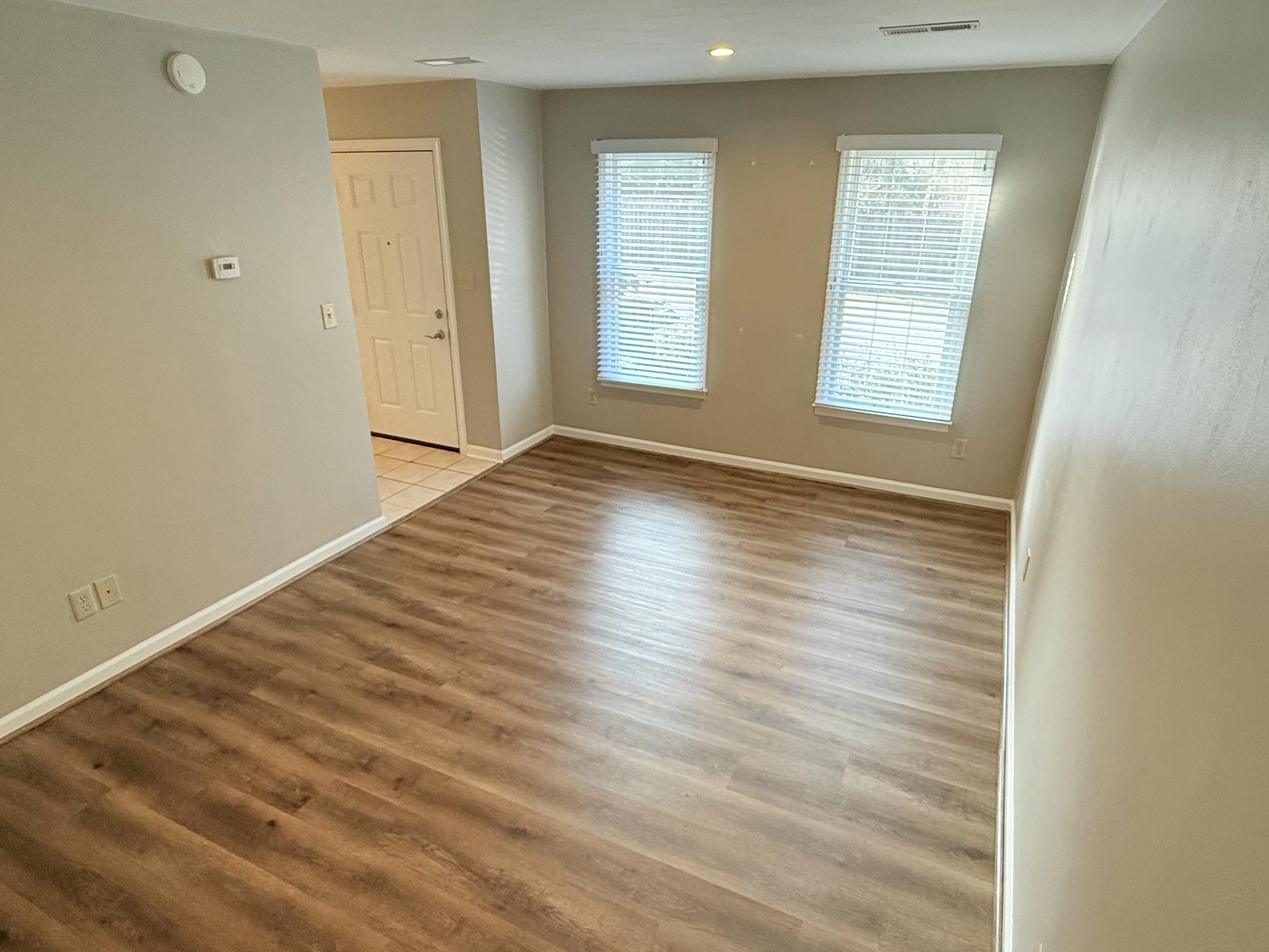 2317 Broadway Avenue Southwest, Unit E Roanoke, VA 24014 - Photo 18 of 20 an empty room with wooden floor and windows