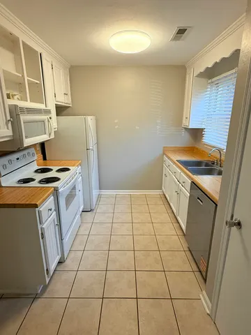 a kitchen with a stove and a refrigerator