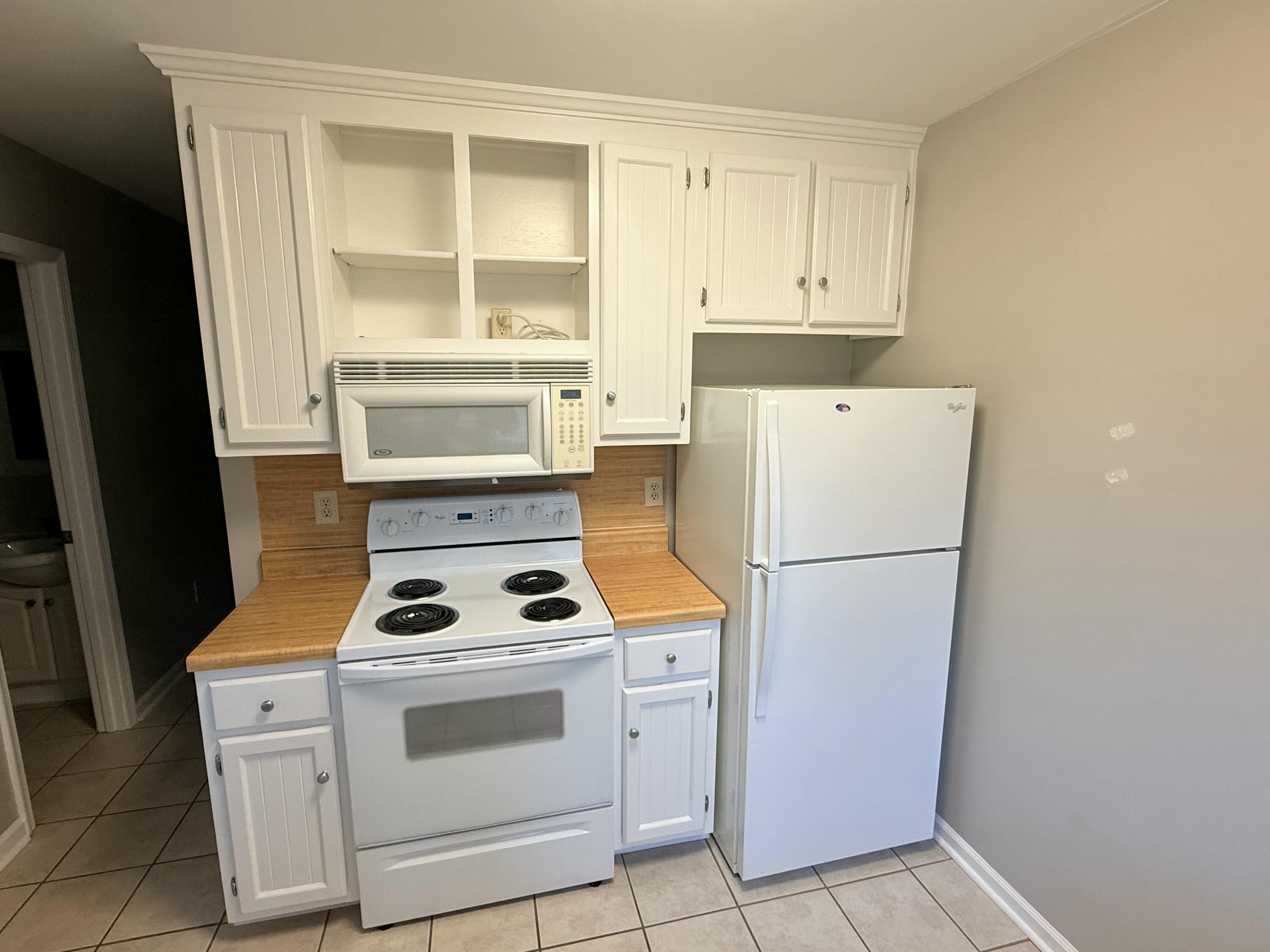2317 Broadway Avenue Southwest, Unit E Roanoke, VA 24014 - Photo 7 of 20 a white refrigerator freezer and a stove sitting inside of a kitchen