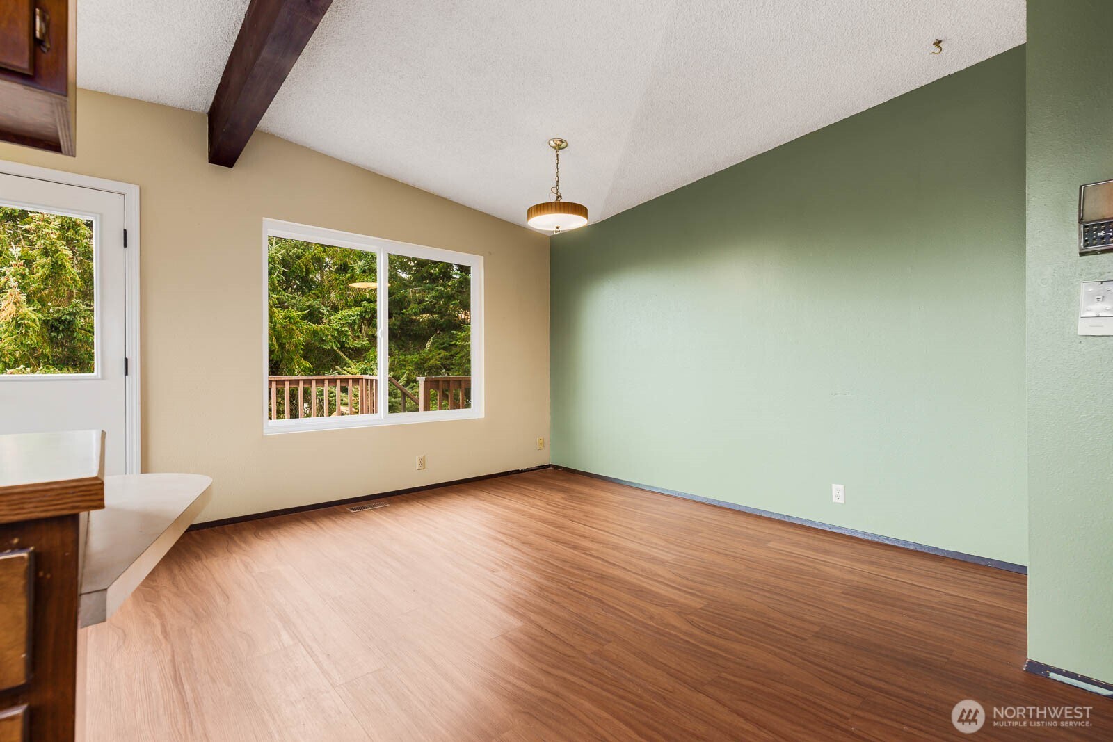 7413 Soundview Drive Edmonds, WA 98026 - Photo 18 of 31 a view of an empty room with wooden floor and a window