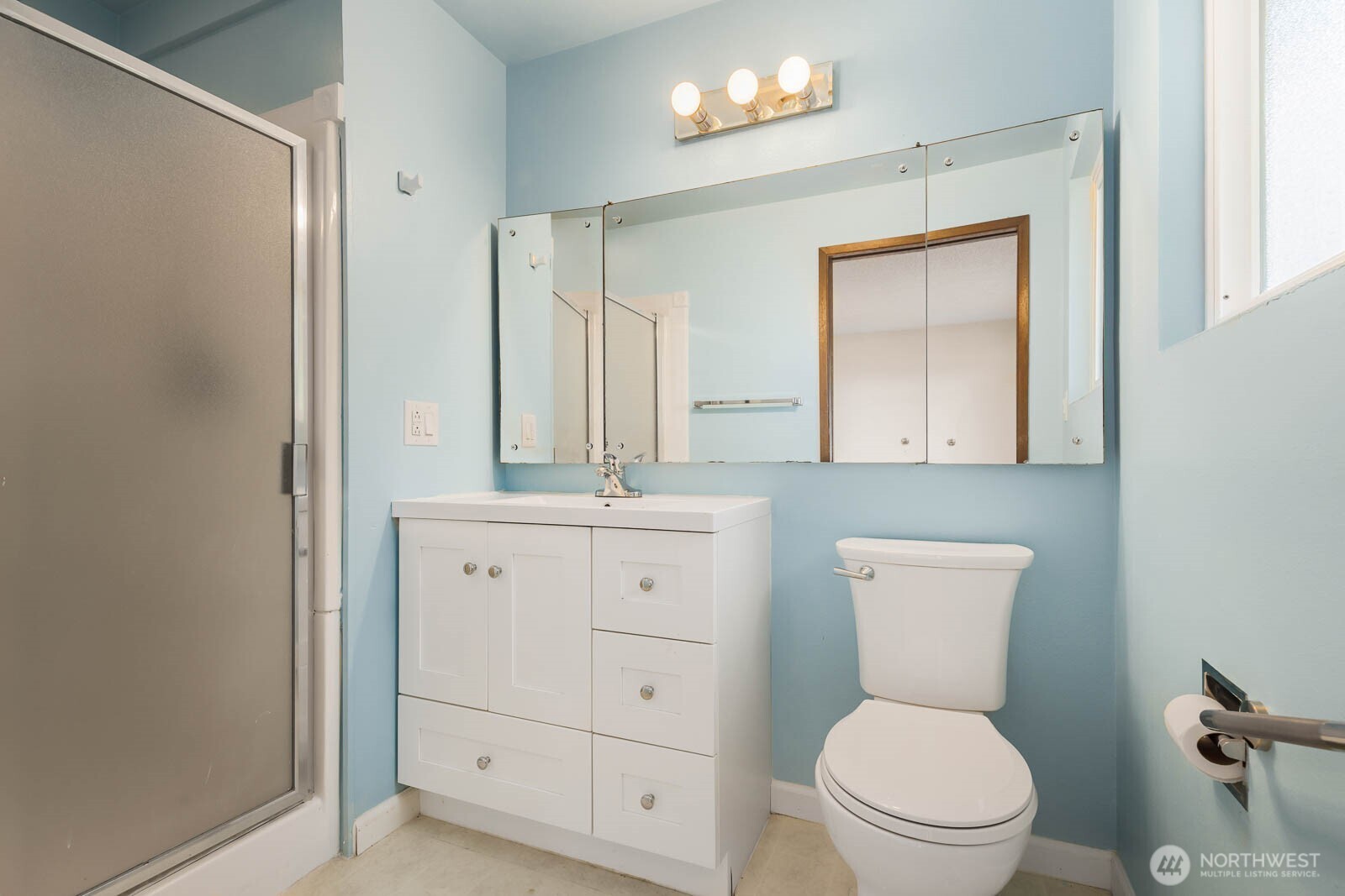 7413 Soundview Drive Edmonds, WA 98026 - Photo 20 of 31 a bathroom with a toilet a sink and mirror