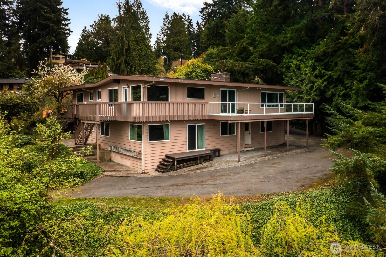 7413 Soundview Drive Edmonds, WA 98026 - Photo 2 of 31 a front view of a house with a yard table and chairs