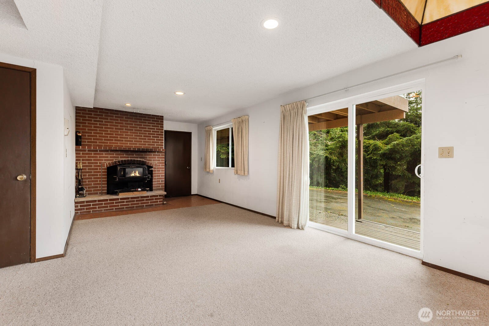 7413 Soundview Drive Edmonds, WA 98026 - Photo 26 of 31 a view of empty room with fireplace