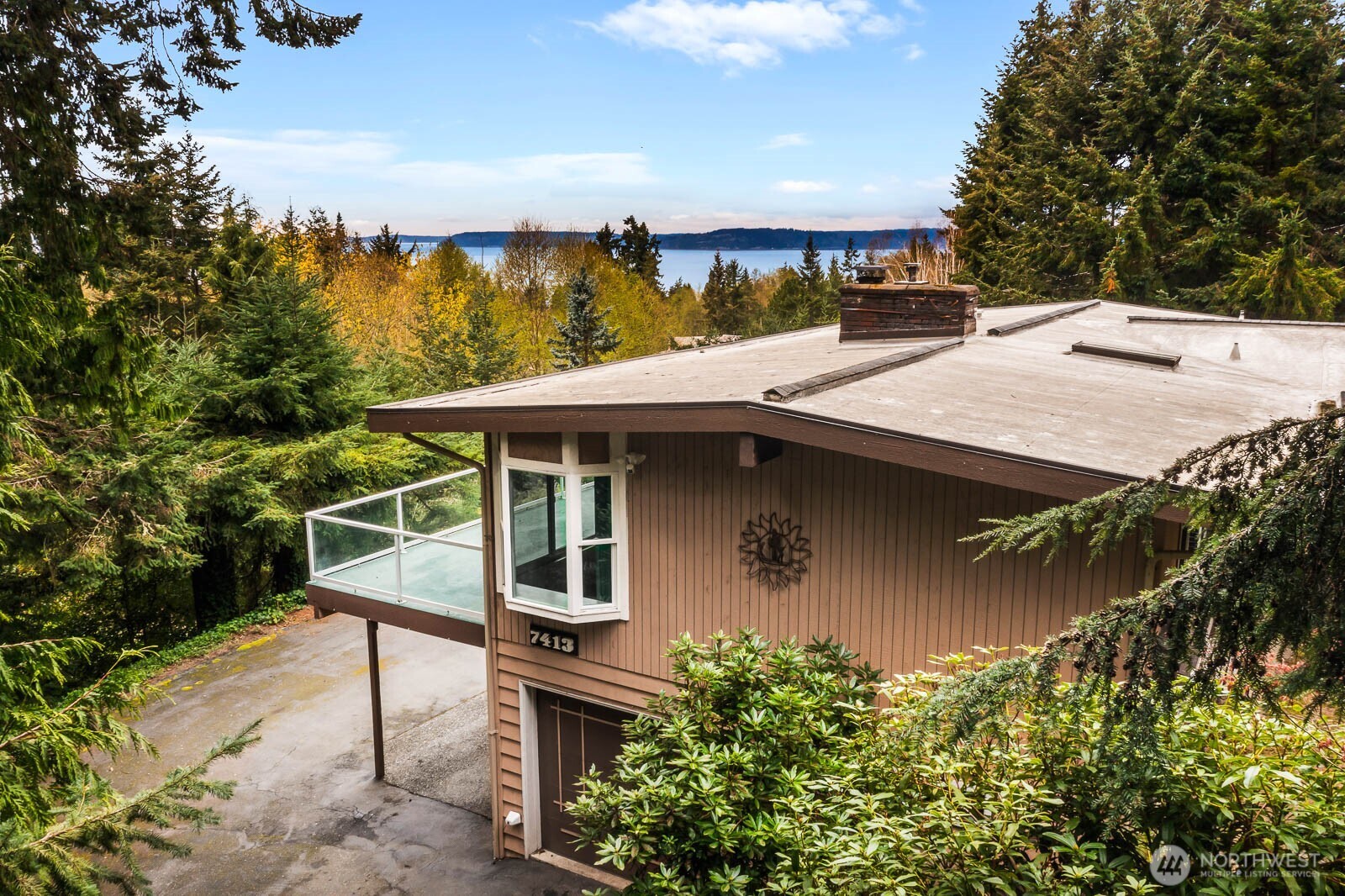 7413 Soundview Drive Edmonds, WA 98026 - Photo 3 of 31 a roof deck with table and chairs plants and trees