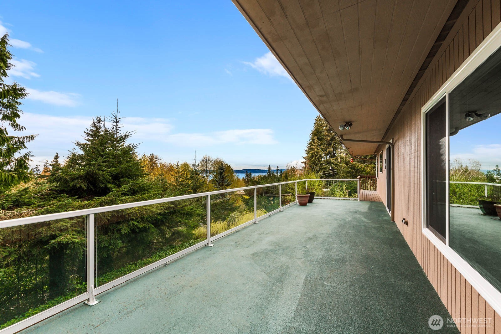 7413 Soundview Drive Edmonds, WA 98026 - Photo 4 of 31 a view of a balcony with floor to ceiling window next to a yard