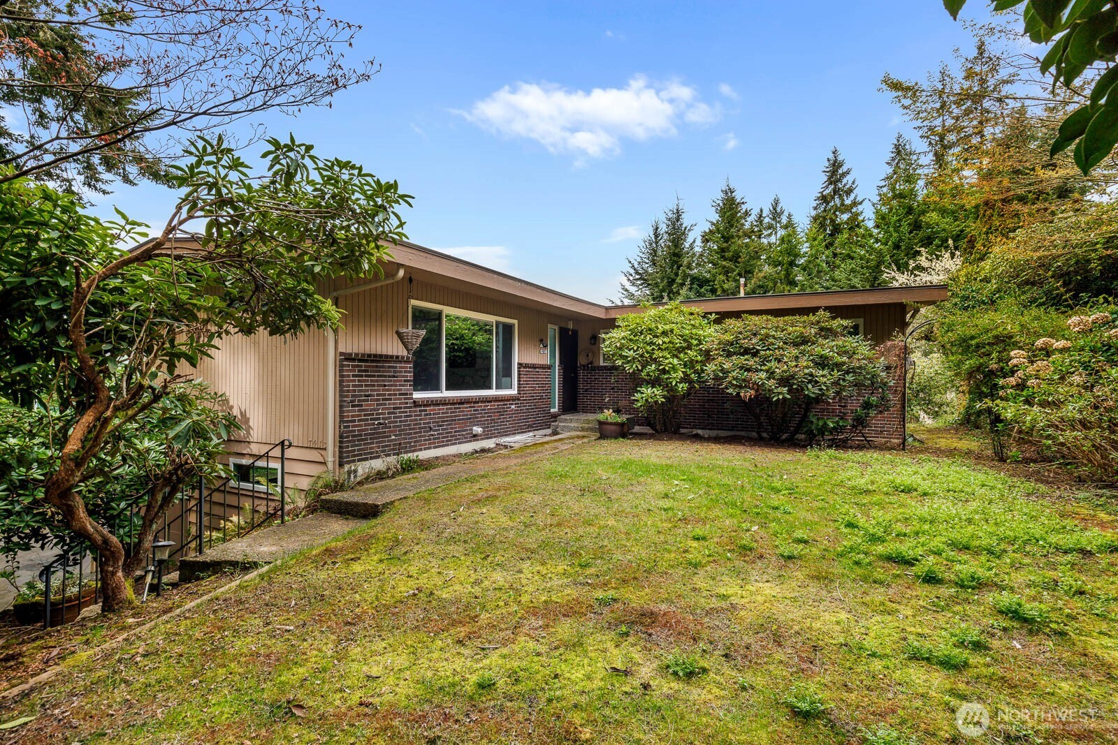 7413 Soundview Drive Edmonds, WA 98026 - Photo 9 of 31 a backyard of a house with lots of green space