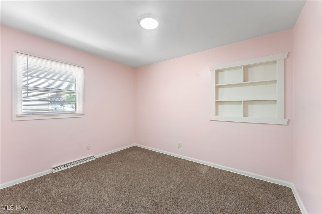 1723 Mathews Road Youngstown, OH 44514 - Photo 21 of 37 Carpeted spare room with built in features and baseboard heating