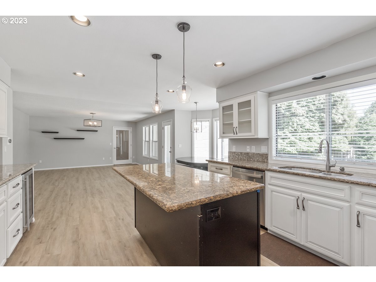 8580 Southwest Thoroughbred Place Beaverton, OR 97008 - Photo 11 of 43 a kitchen with granite countertop a sink cabinets and window