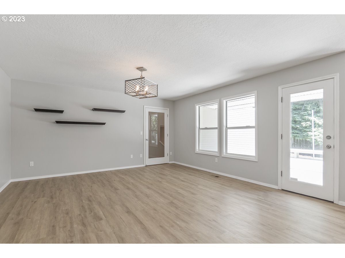 8580 Southwest Thoroughbred Place Beaverton, OR 97008 - Photo 13 of 43 an empty room with wooden floor and windows