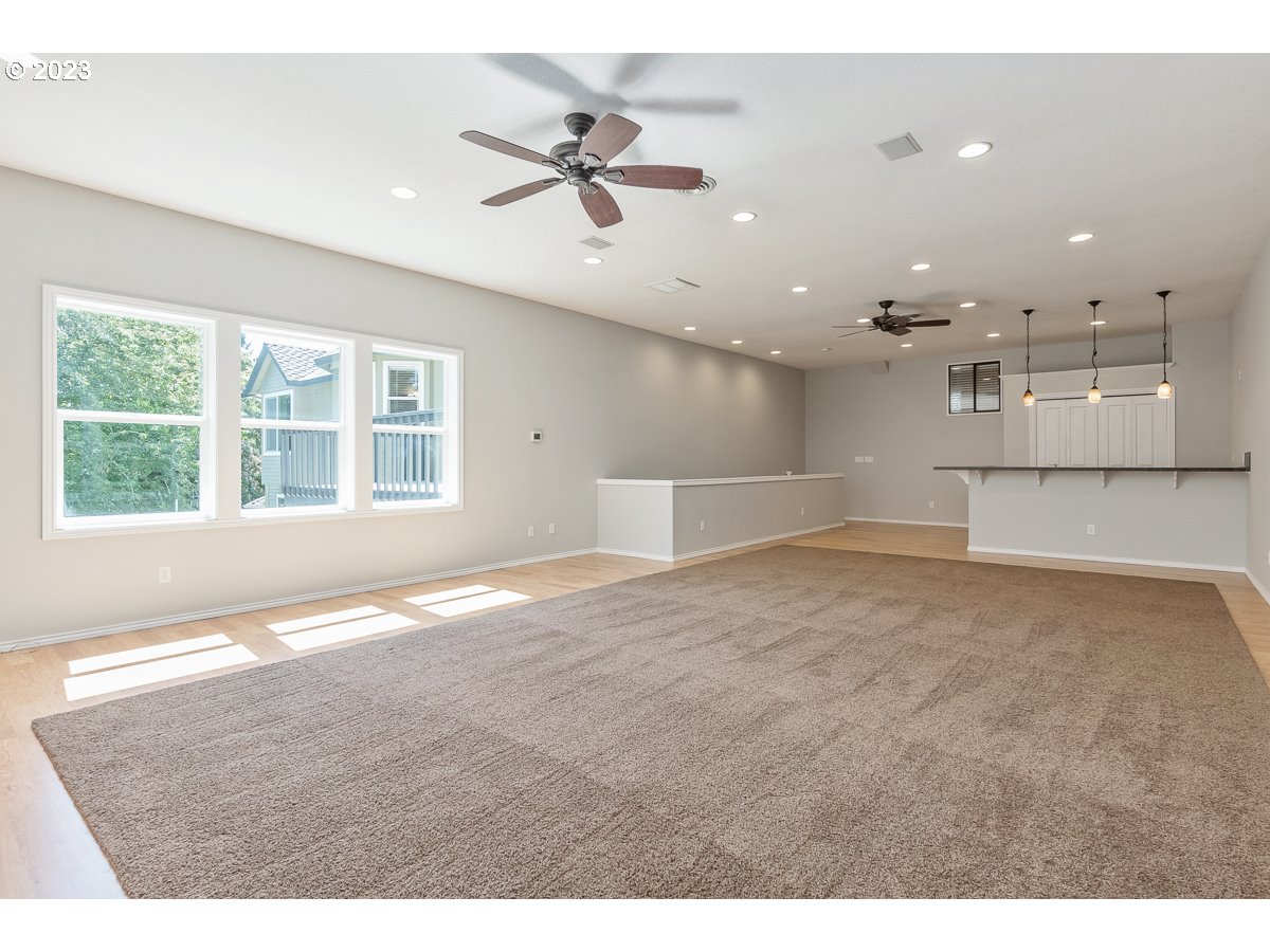 8580 Southwest Thoroughbred Place Beaverton, OR 97008 - Photo 18 of 43 a view of empty room with windows and ceiling fan