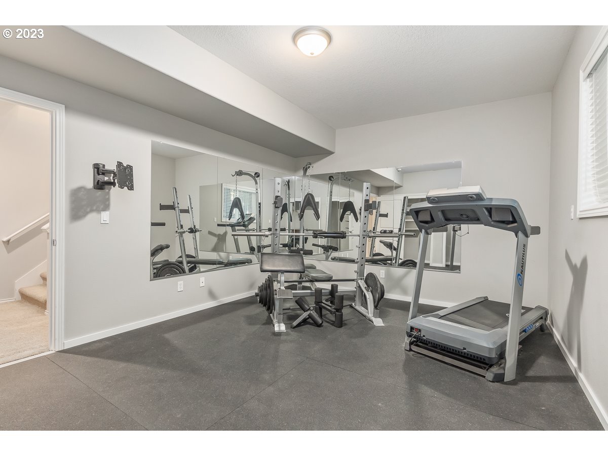 8580 Southwest Thoroughbred Place Beaverton, OR 97008 - Photo 20 of 43 a living room with furniture and a wooden floor