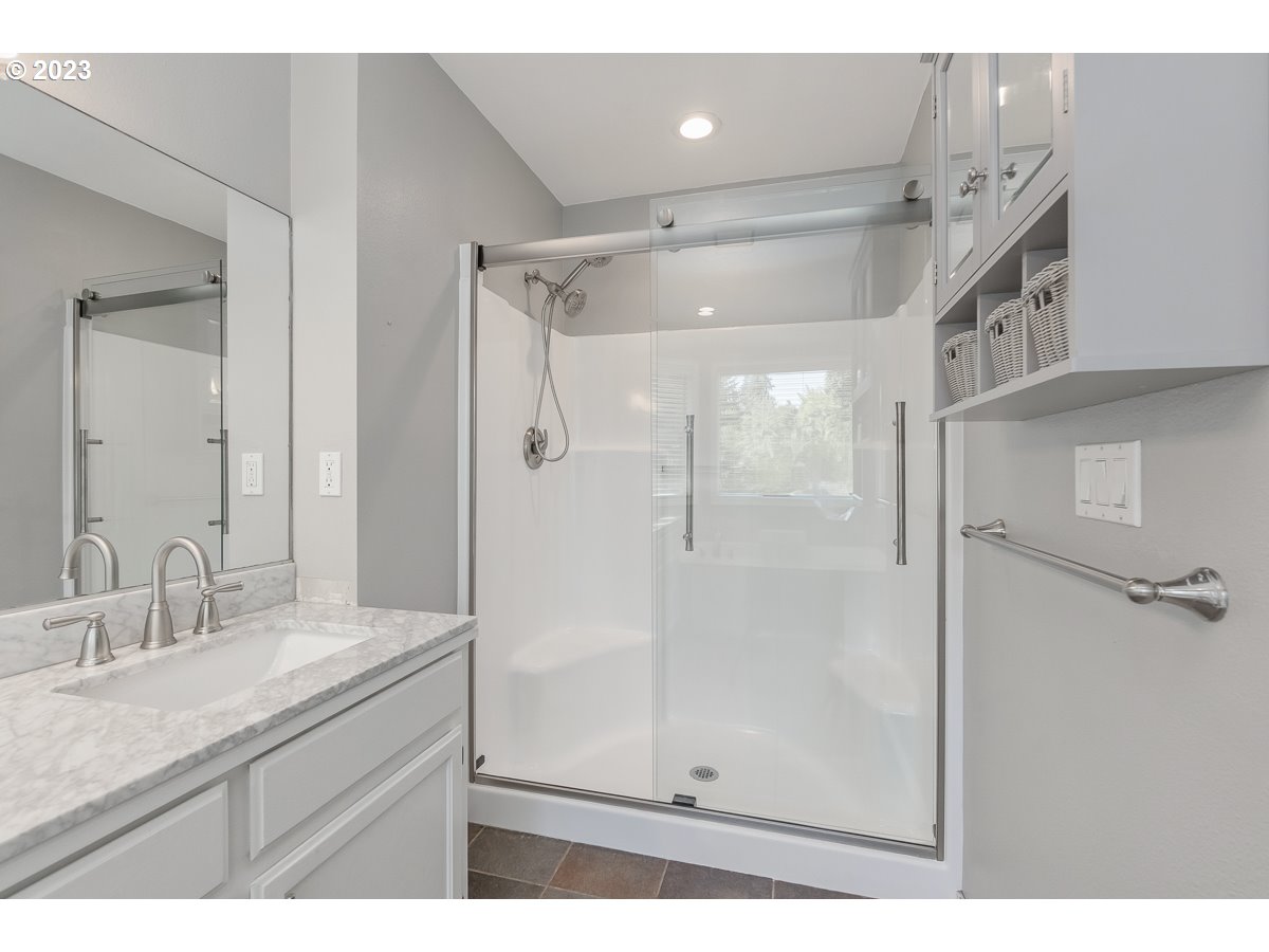 8580 Southwest Thoroughbred Place Beaverton, OR 97008 - Photo 24 of 43 a bathroom with a granite countertop shower sink vanity and mirror