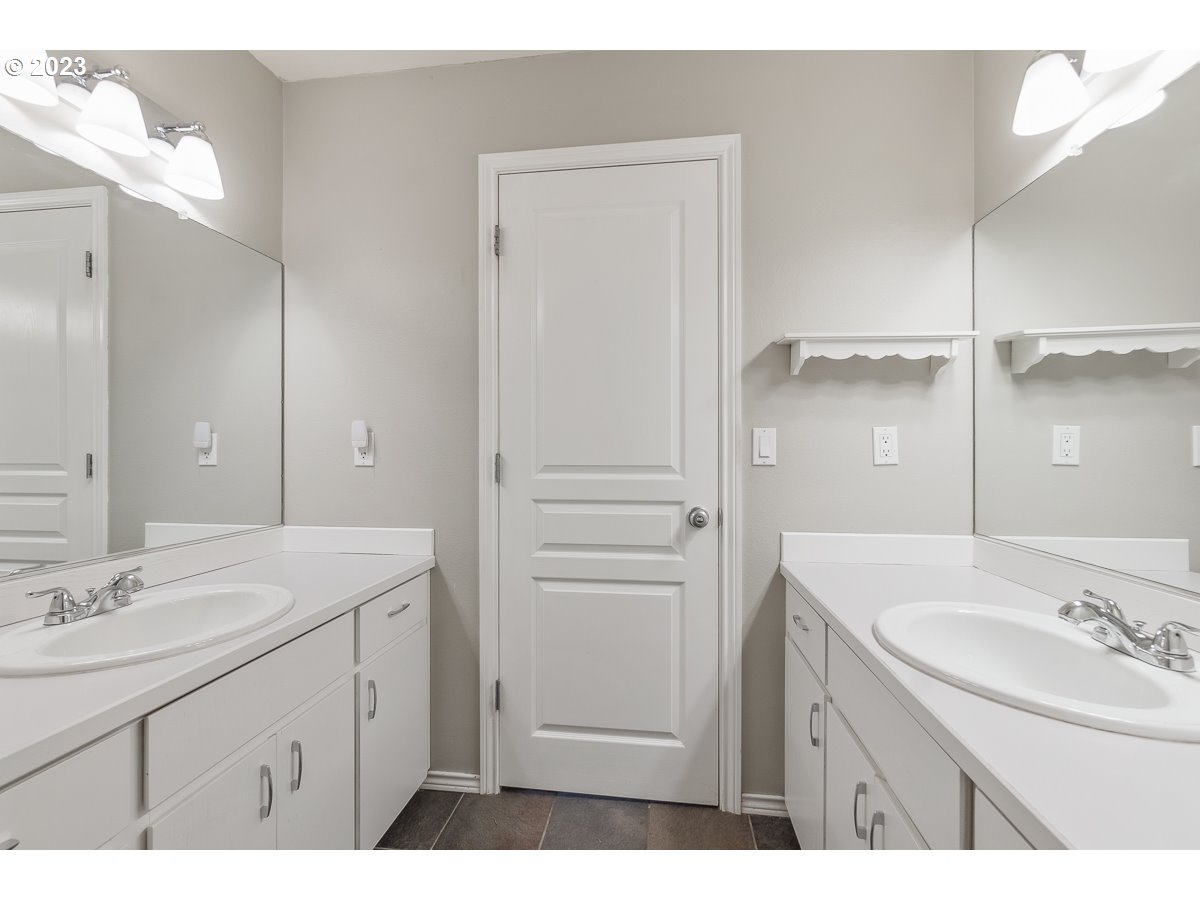 8580 Southwest Thoroughbred Place Beaverton, OR 97008 - Photo 31 of 43 a bathroom with a sink double vanity and a mirror